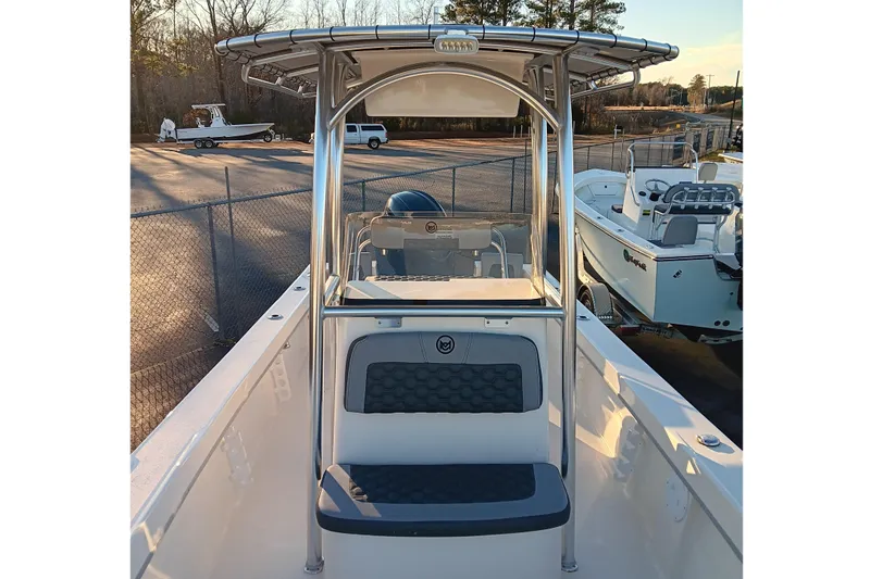 Slide: The Image of 2026 May-Craft 238 CC boat with T-top and seating, parked outdoors. - 8