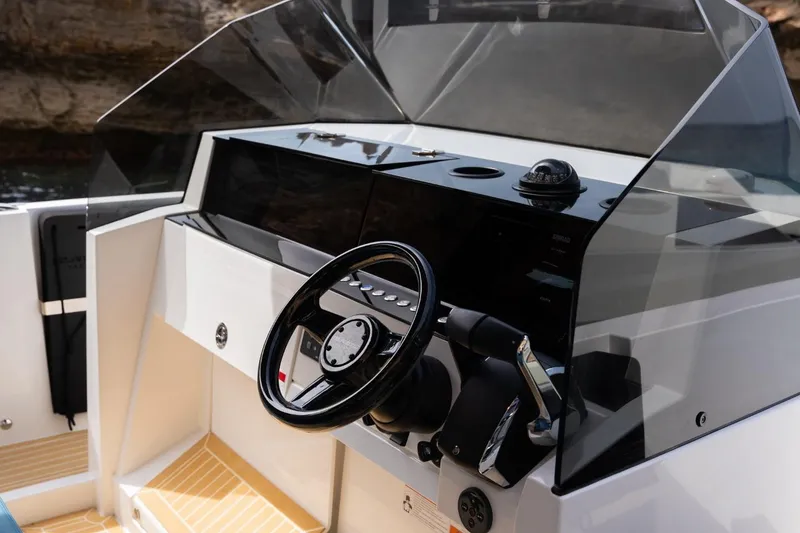 Slide: The Image of 2026 De Antonio Yachts D29 helm with modern steering and navigation controls. - 20