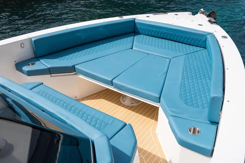 Slide: The Image of Luxurious seating on 2026 De Antonio Yachts D29, featuring blue upholstery and cup holders. - 23