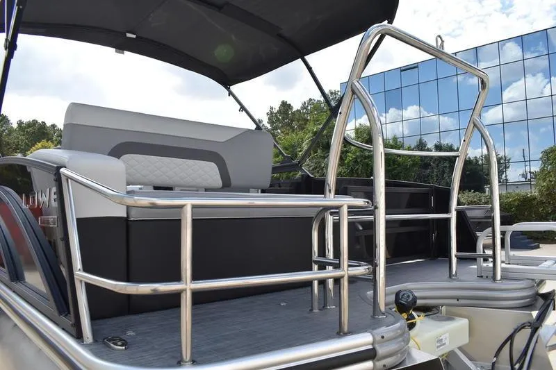 Slide: The Image of 2023 Lowe SS 230 DV pontoon boat with sleek railing and modern seating design. - 10