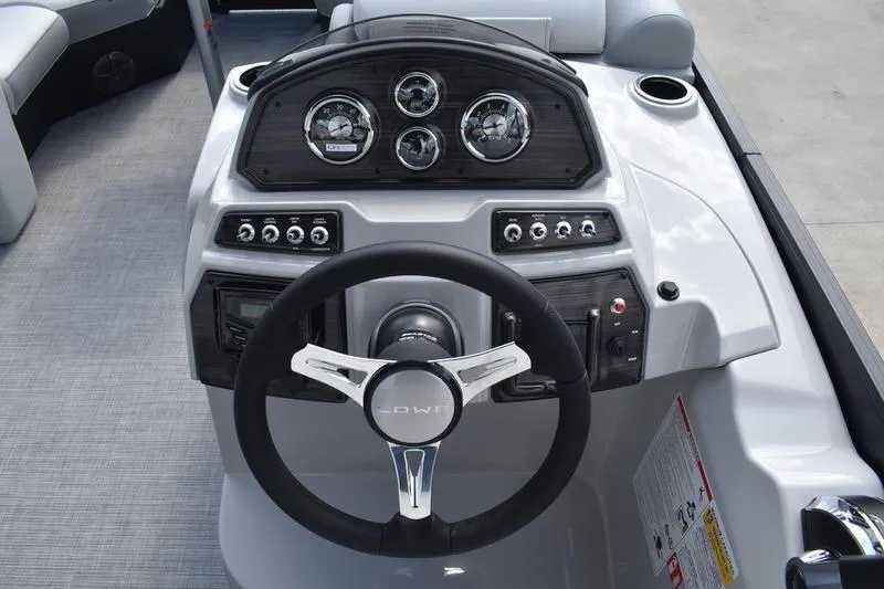 Slide: The Image of 2023 Lowe SS 230 DV boat dashboard with steering wheel and instrument panel. - 27