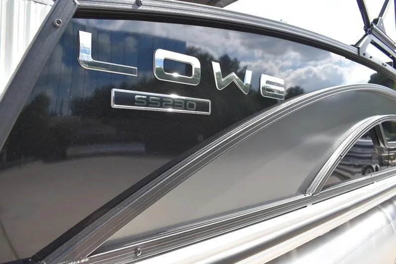 Slide: The Image of 2023 Lowe SS 230 DV boat exterior with sleek black design and logo. - 3