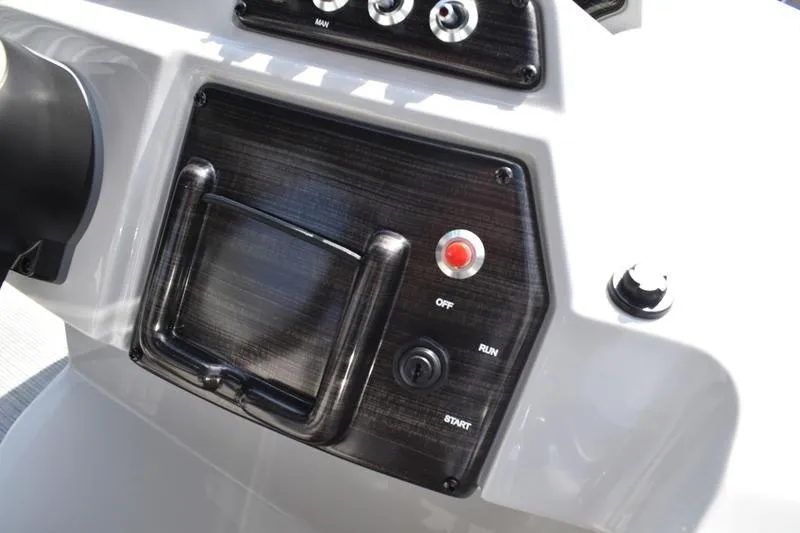 Slide: The Image of 2023 Lowe SS 230 DV boat dashboard with controls and switches. - 33