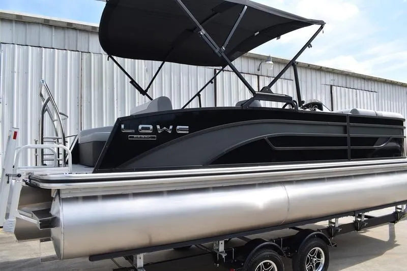 Slide: The Image of 2023 Lowe SS 230 DV pontoon boat with canopy, displayed on a trailer. - 4