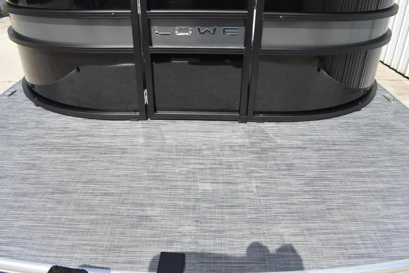Slide: The Image of 2023 Lowe SS 230 DV pontoon boat with sleek black exterior and textured deck. - 5