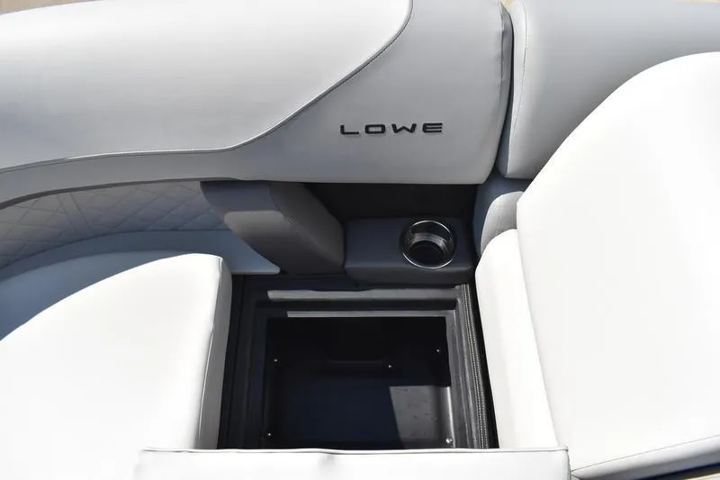 Slide: The Image of 2023 Lowe SS 230 DV boat interior with storage compartment and cup holder. - 18