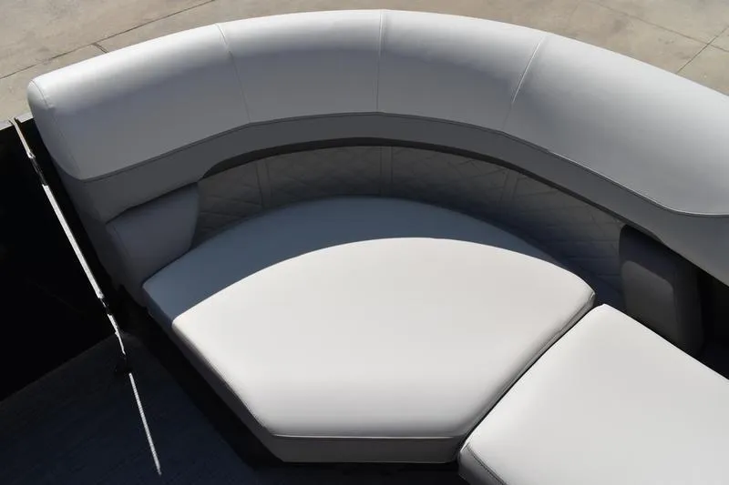 Slide: The Image of 2023 Lowe SS 230 DV boat interior with curved seating and light upholstery. - 19