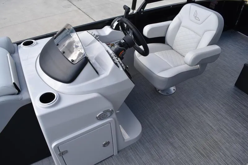 Slide: The Image of 2023 Lowe SS 230 DV boat interior with steering console and cushioned captain's chair. - 24
