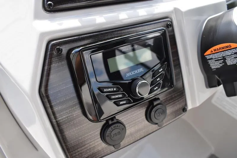 Slide: The Image of 2023 Lowe SS 230 DV boat dashboard with Kicker media center and USB port. - 30