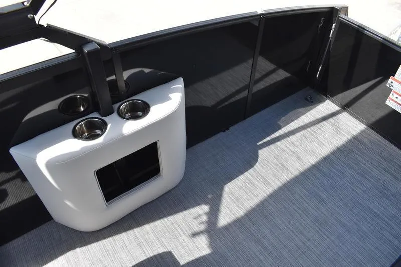 Slide: The Image of 2023 Lowe SS 230 DV boat interior with cup holders and storage compartment. - 31