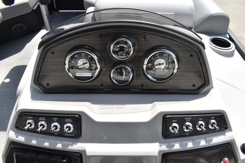 Slide: The Image of 2023 Lowe SS 230 DV boat dashboard with gauges and control switches. - 32