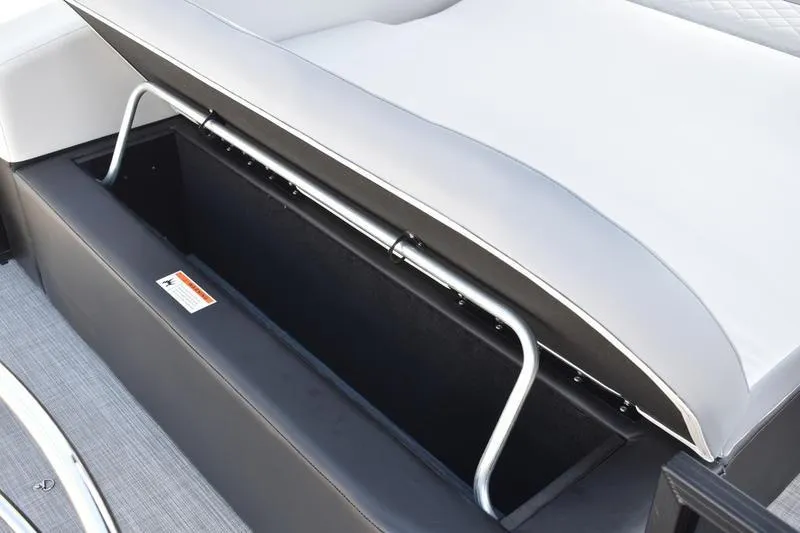 Slide: The Image of 2023 Lowe SS 230 DV boat storage compartment with cushioned seating and metal support. - 38