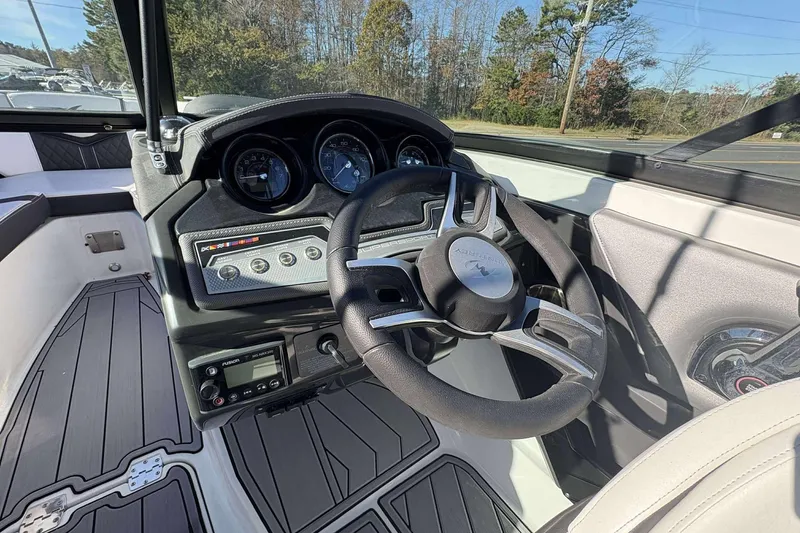 Slide: The Image of 2023 Monterey 238SS Super Sport boat dashboard with steering wheel and control panel. - 10