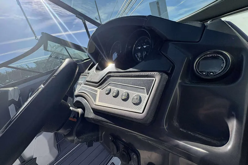 Slide: The Image of 2023 Monterey 238SS Super Sport dashboard with steering wheel and depth gauge. - 14