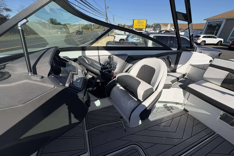 Slide: The Image of Interior of 2023 Monterey 238SS Super Sport boat with modern seating and dashboard. - 15