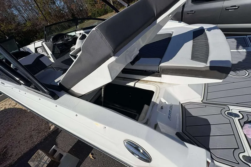 Slide: The Image of 2023 Monterey 238SS Super Sport boat with open storage compartment and seating area. - 18