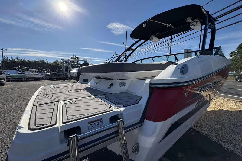 Slide: The Image of 2023 Monterey 238SS Super Sport boat with swim platform under sunny sky. - 19