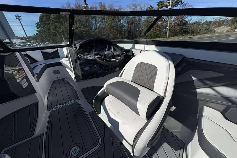 Slide: The Image of 2023 Monterey 238SS Super Sport boat interior with steering wheel and seating. - 23