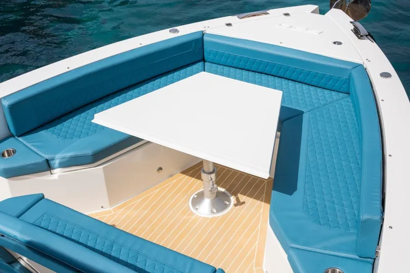 Slide: The Image of Luxurious seating area on 2026 De Antonio Yachts D29 with turquoise cushions and white table. - 22