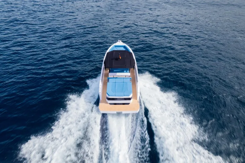 Slide: The Image of 2026 De Antonio Yachts D29 cruising on open water, aerial view. - 6