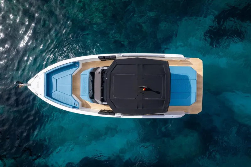 Slide: The Image of 2026 De Antonio Yachts D29, aerial view, sleek design, floating on clear blue water. - 9
