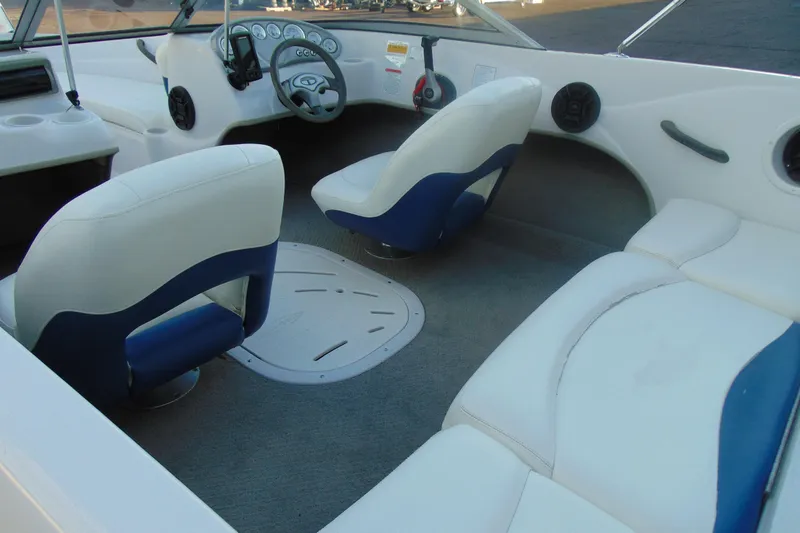 Slide: The Image of 2007 Tahoe Q4 I/O Sport boat interior with white and blue seating, steering wheel, and dashboard. - 7