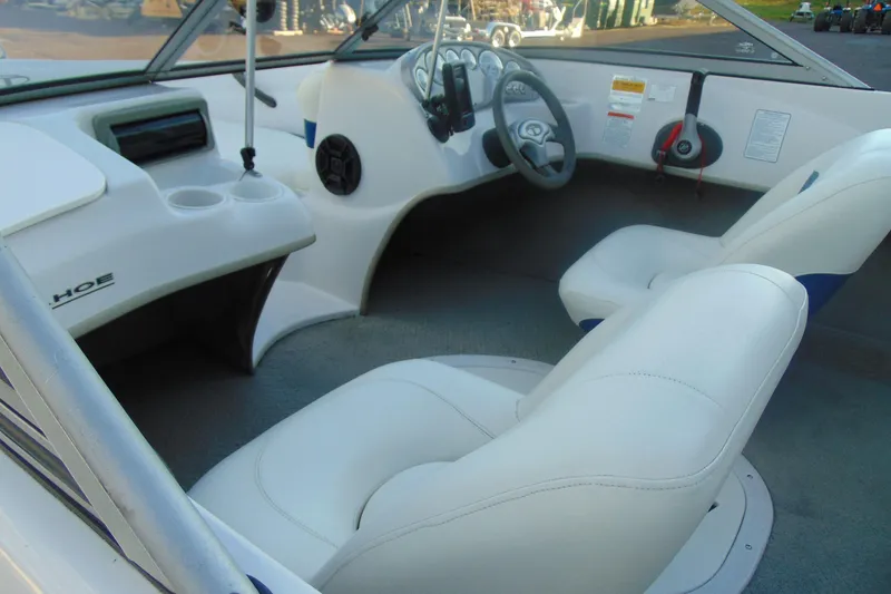 Slide: The Image of 2007 Tahoe Q4 I/O Sport boat interior with white seating and steering console. - 9
