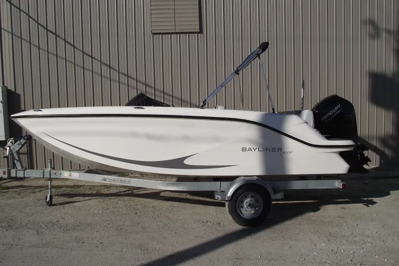 The Image of 2026 Bayliner M19 boat on trailer, parked outdoors, side view. - 0