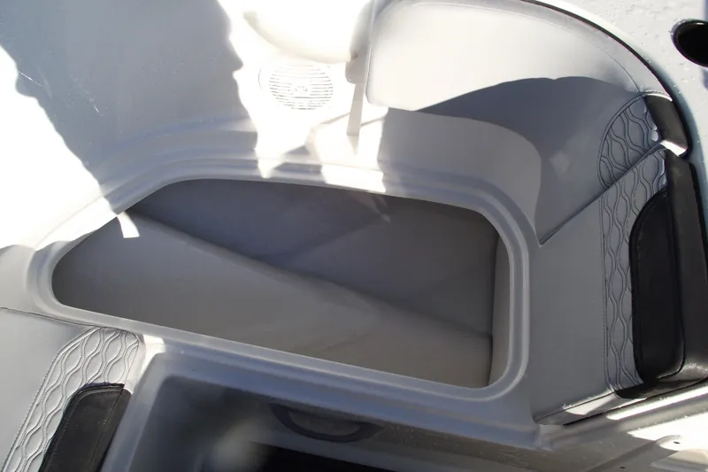 Slide: The Image of 2026 Bayliner M19 boat interior storage compartment with cushioned seating. - 11