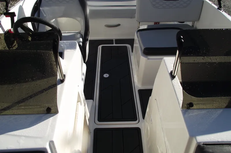 Slide: The Image of Interior view of 2026 Bayliner M19 boat, featuring sleek seating and modern design. - 12
