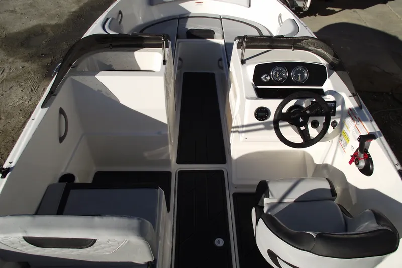 Slide: The Image of 2026 Bayliner M19 boat interior with steering wheel and seating arrangement. - 13