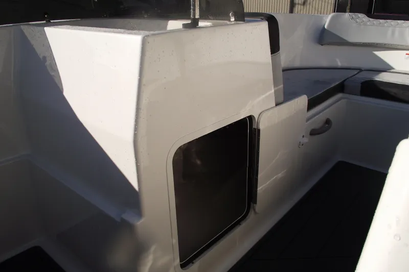 Slide: The Image of 2026 Bayliner M19 boat interior with seating and storage compartment. - 18