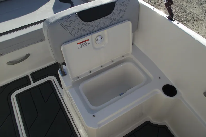 Slide: The Image of 2026 Bayliner M19 boat interior with open storage compartment and seating. - 23