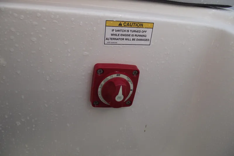 Slide: The Image of Red switch on 2026 Bayliner M19 boat with caution label above. - 26