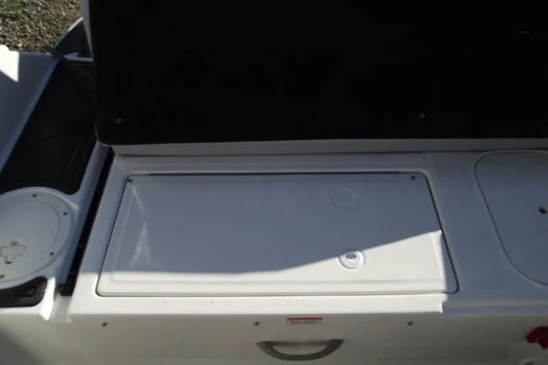 Slide: The Image of 2026 Bayliner M19 boat storage compartment with closed lid, showcasing sleek design. - 27