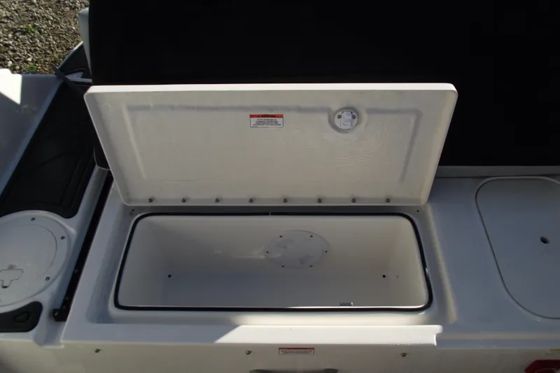 Slide: The Image of 2026 Bayliner M19 boat storage compartment with open lid, showcasing interior space. - 28
