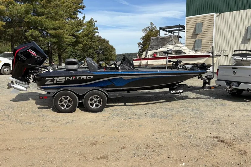 The Image of 2024 Nitro Z19 boat on trailer, parked outdoors near a building. - 0
