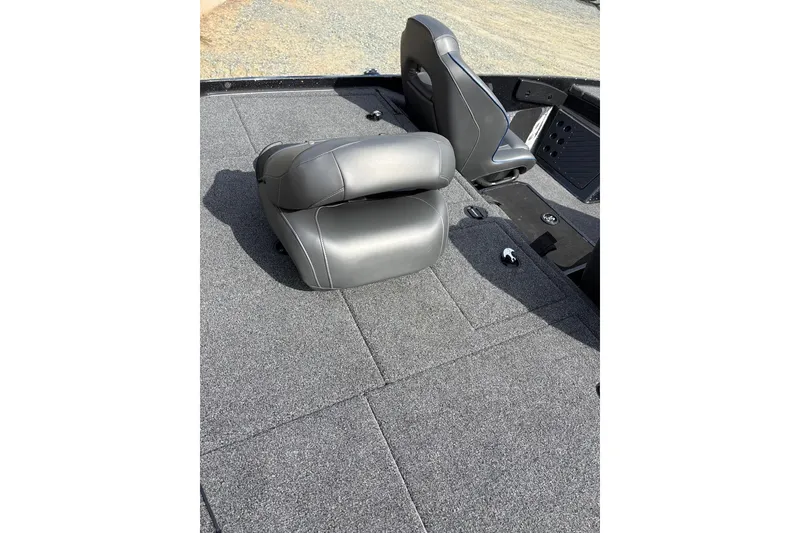 Slide: The Image of 2024 Nitro Z19 boat interior with gray seating and carpeted flooring. - 9