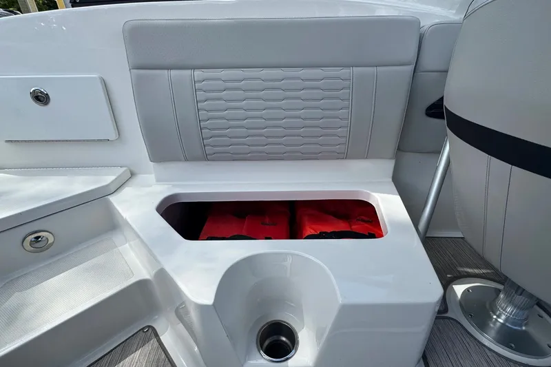 Slide: The Image of 2021 Sea Ray SPX 230 Outboard boat interior with storage compartment and life jackets. - 10