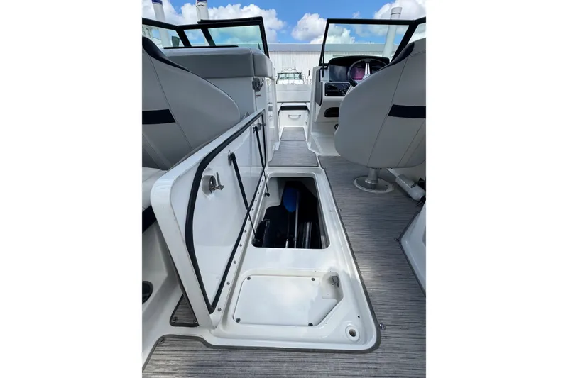 Slide: The Image of 2021 Sea Ray SPX 230 Outboard interior with open storage compartment. - 11
