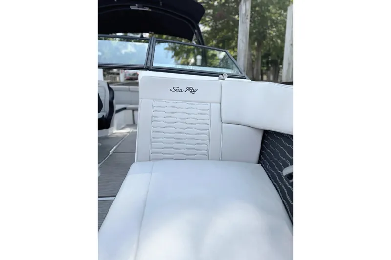 Slide: The Image of 2021 Sea Ray SPX 230 Outboard interior with white seating and logo detail. - 15