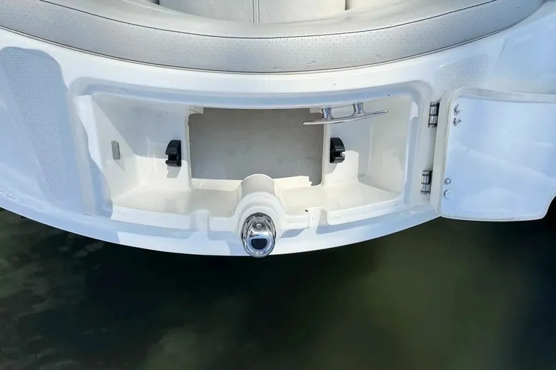 Slide: The Image of 2021 Sea Ray SPX 230 Outboard boat storage compartment with open hatch. - 16