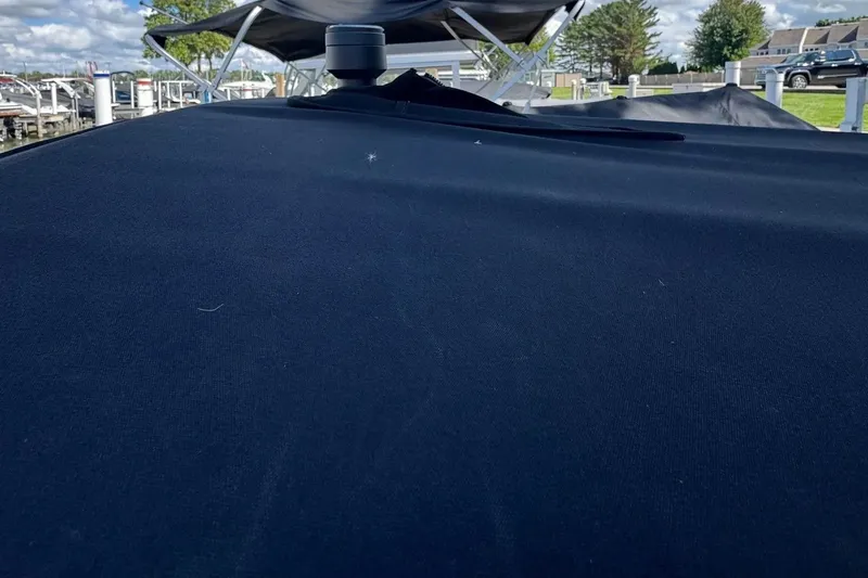 Slide: The Image of Covered 2021 Sea Ray SPX 230 Outboard boat at a marina. - 17