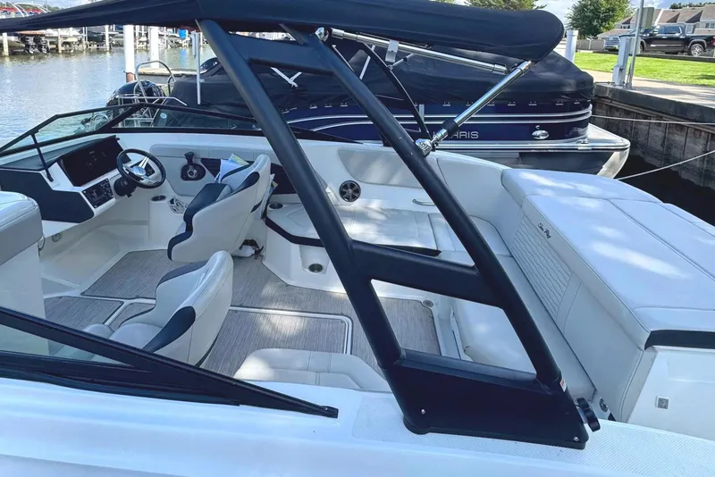 Slide: The Image of 2021 Sea Ray SPX 230 Outboard boat interior with sleek seating and modern dashboard. - 18