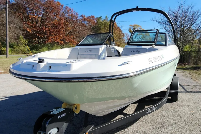 Slide: The Image of 2021 Sea Ray SPX 230 Outboard boat on trailer, parked outdoors. - 19