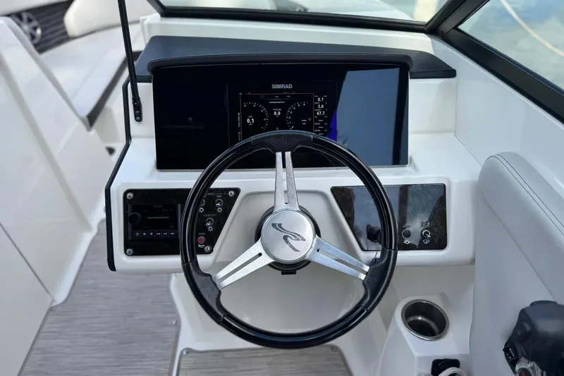 Slide: The Image of Steering console of 2021 Sea Ray SPX 230 Outboard with digital display and controls. - 2