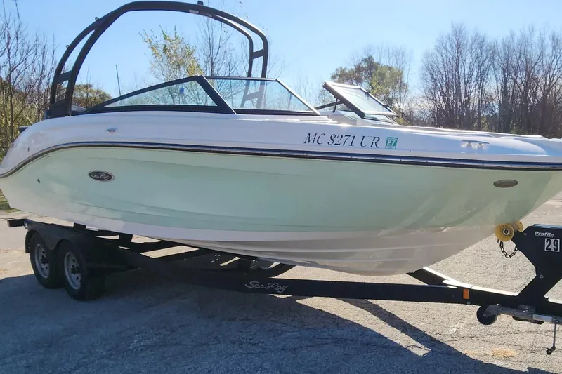 Slide: The Image of 2021 Sea Ray SPX 230 Outboard boat on trailer, parked outdoors. - 21