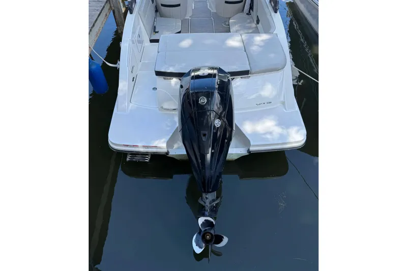 Slide: The Image of 2021 Sea Ray SPX 230 Outboard boat with sleek design, docked in calm water. - 25