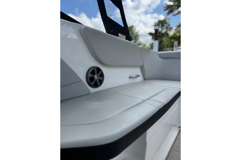 Slide: The Image of 2021 Sea Ray SPX 230 Outboard boat interior with cushioned seating and speaker. - 9