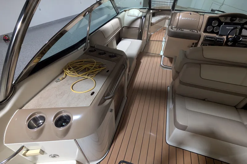 Slide: The Image of 2014 Formula 350 Crossover Bowrider interior with beige seating and wood flooring. - 11